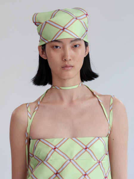 A model walks the runway at the Emilia Wickstead show during London Fashion Week September 2025 wearing a pastel green...