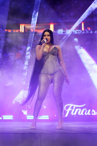 Cardi B performs at the NBA Game 3 game at Madison Square Garden. She wears a catsuit and long calflength hair.